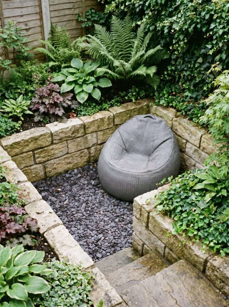 Sunken garden seating area with slate chips, limestone borders, and a gray bean bag.
