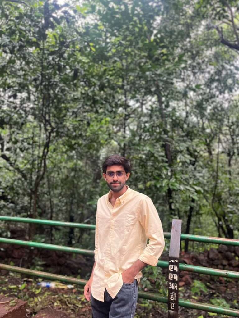 Aagam Desai, founder of SpruceTouch, standing outdoors surrounded by greenery