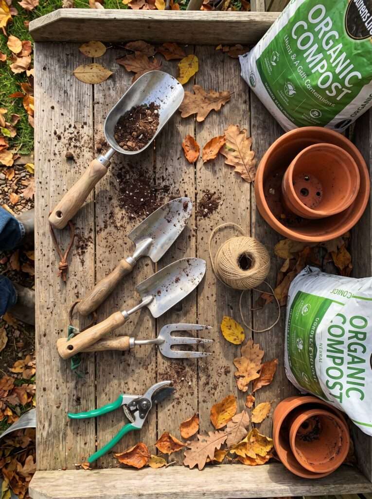 Overhead view of a backyard potting bench setup with garden tools
